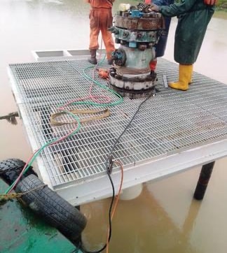 Crew working on a finished grating deck around a wellhead