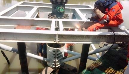 Platform frame being welded around a wellhead
